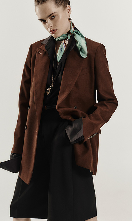 Model with Max Mara blazer in earth-colour wool Grain de Poudre, light blue knotted foulard and black skirt.