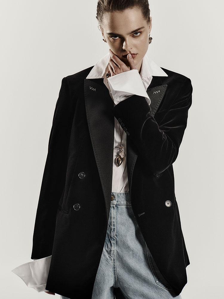 Model with black velvet Max Mara Sartoriale double-breasted blazer, with white shirt.